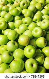 fresh raw lot of green apples on counter