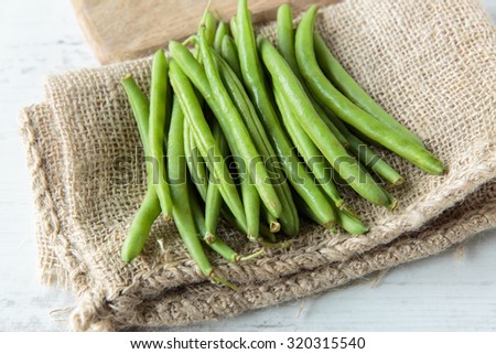 Fresh raw green beans on jute cloth