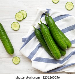 Fresh Raw Green Cucumbers Over White Wooden Surface, Top View. Flat Lay, From Above, Overhead. 