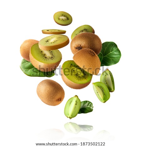 Fresh raw kiwi with leaves falling in the air isolated on white background. Food levitation concept. High resolution image