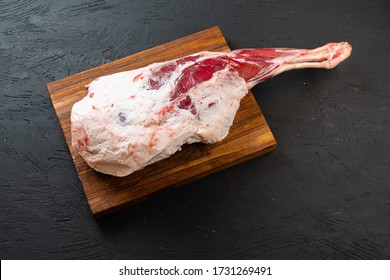 Fresh raw lamb leg ready for roasting on wooden board, top view. - Powered by Shutterstock