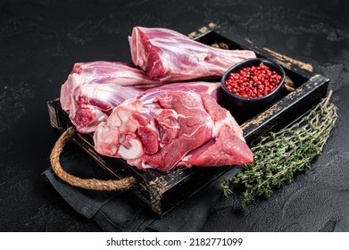 Fresh Raw lamb shanks with herbs and spices, mutton meat. Black background. Top view. - Shutterstock ID 2182771099