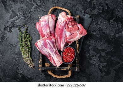 Fresh Raw lamb shanks with herbs and spices, mutton meat. Black background. Top view. - Powered by Shutterstock