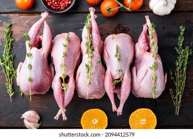 Fresh  raw meat quail ready for cooking, flat lay, on dark wooden background