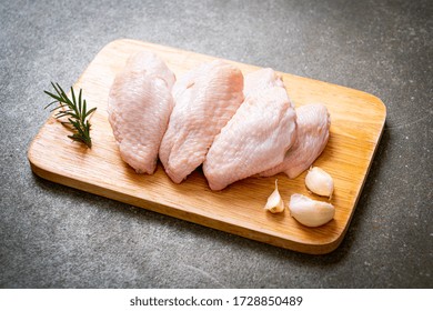 Fresh Raw Middle Chicken Wings On Wooden Board With Ingredients