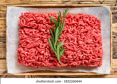 Fresh Raw Mince Beef, Ground Meat On Butcher Paper. Wooden Background. Top View