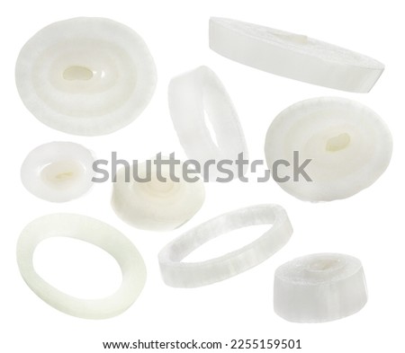 Fresh raw onion rings falling on white background