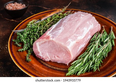 Fresh Raw Pork Loin Meat With Thyme And Rosemary On Rustic Plate. Dark Background. Top View