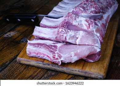 fresh raw pork loin with ribs on a wooden background