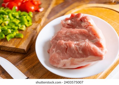 Fresh Raw pork meat on wooden cutting board, High-Quality fresh ingredients, culinary ideas and home cooking, traditional methods of preparing dishes - Powered by Shutterstock