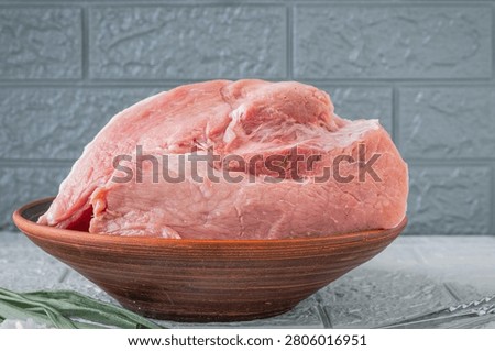 Fresh raw pork meat in rustic ceramic bowl ready for home cooking