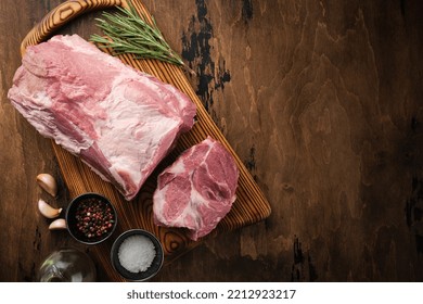 Fresh Raw Pork Neck With Salt And Pepper, Overhead Shot. Pork Neck Meat On A Wooden Board Top View. Copyspace.