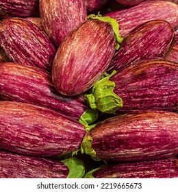 Fresh Raw Purple Striped Aubergine Or Eggplant At A Food Market