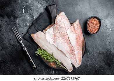 Fresh Raw red perch fillet, Snapper fish on a wooden board. Wooden background. Top view.
