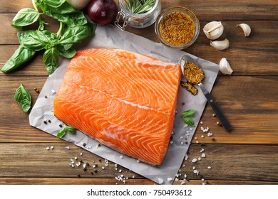 Fresh Raw Salmon Fillet With Honey Mustard Marinade On Wooden Table