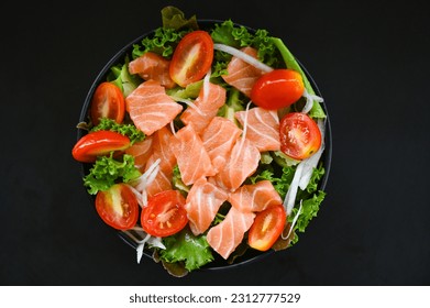 fresh raw salmon fish cooking food seafood salmon fish healthy food black background, salmon salad food salmon fillet with vegetable lettuce leaf tomato herb and spices - Powered by Shutterstock