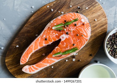 Fresh Raw Salmon Fish Steak With Spices On Dark Stone Background. Creative Layout Made Of Fish, Top View, Flat Lay, Mockup, Overhead. Healthy Food Concept