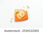 Fresh raw salmon marbled fillet isolated on white background with lemon, coarse salt, green herbs top view. Healthy nutrition and balanced diet