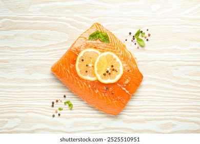 Fresh raw salmon marbled fillet on white rustic wooden table background with lemon, coarse salt, green herbs top view. Healthy cooking and balanced diet - Powered by Shutterstock