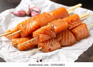 Fresh raw salmon skewers with herbs and ready to cook