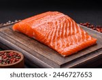 Fresh raw salmon steak with spices and herbs prepared for grilled baking. Healthy seafood food