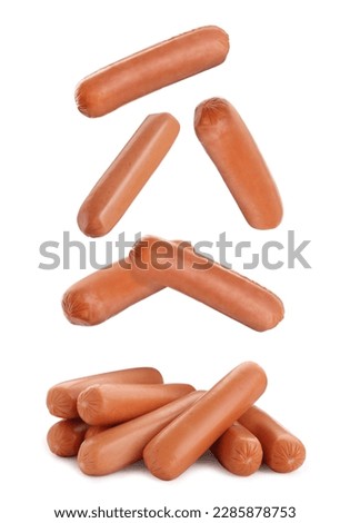 Fresh raw sausages falling on white background