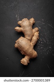 Fresh raw single ginger root black dark background healthy alternative medicine immunity