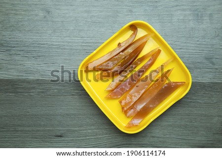 fresh raw squid,octopus sliced on square plate  on wood, wooden background,set shabu, hot pot ingredients.