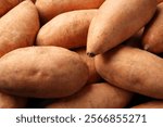 Fresh raw sweet potatoes as background, closeup