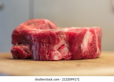 Fresh Raw Veal Or Beef Leg Or Neck Bones With Meat. Soup And Stock Ingredients, Close Up Shot On Wooden Kitchen Board, No People.