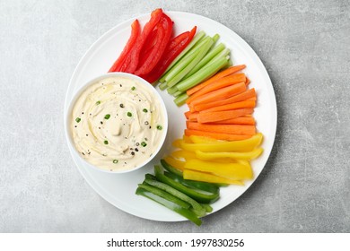 Fresh Raw Vegetable Sticks And Sauce On Grey Table, Top View