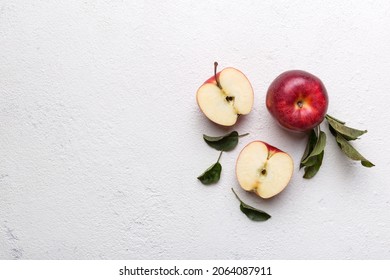 Fresh red apples with green leaves on wooden table. On wooden background. Top view free space for text.