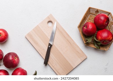 Fresh red apples with green leaves on table. cutting board with knife. Top view. - Powered by Shutterstock