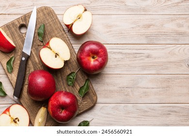 Fresh red apples with green leaves on table. cutting board with knife. Top view. - Powered by Shutterstock