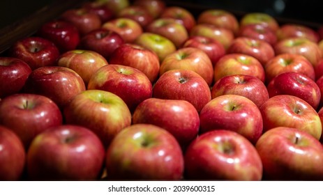 Fresh Red Apples On The Market Counter. Apples In The Cardboard Box On The Grocery Shelf. Close Up View Of Fruits In Supermarket. Healthy Eating And Vegetarianism