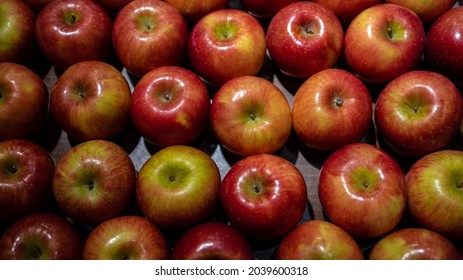 Fresh Red Apples On The Market Counter. Apples In The Cardboard Box On The Grocery Shelf. Close Up View Of Fruits In Supermarket. Healthy Eating And Vegetarianism