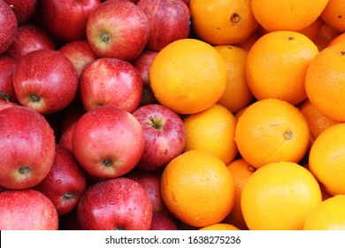 Fresh red apples and orange in the shop