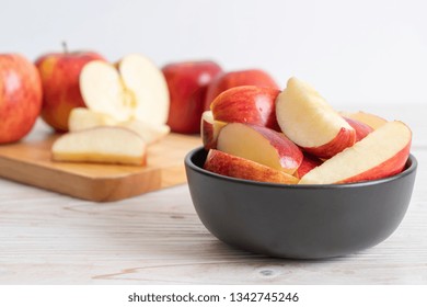 fresh red apples sliced bowl on wood background - Powered by Shutterstock