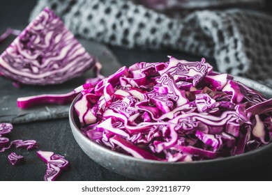 Fresh red cabbage, cut into pieces and strips, on gray table - Powered by Shutterstock