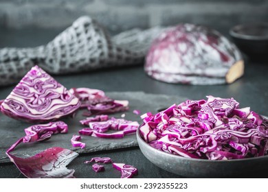 Fresh red cabbage, cut into pieces and strips, on gray table. - Powered by Shutterstock