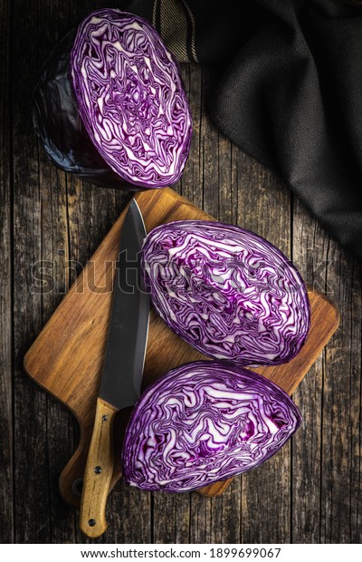 Fresh red cabbage\
on cutting board. Top\
view.