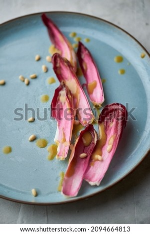 Fresh red chicory or radicchio salad with pine nuts and winegret. Top view. Home cuisine. Healthy food nutrition. Stock photo © 