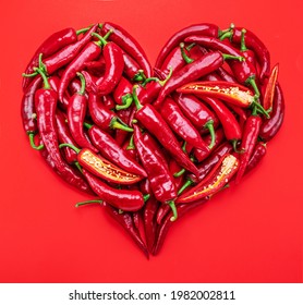 Fresh red chilli pepper in the shape of heart isolated on white background.