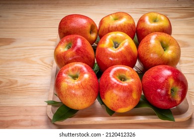 Fresh Red Envy Apple In Wooden Plate On Wooden Background