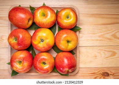 Fresh Red Envy Apple In Wooden Plate On Wooden Background