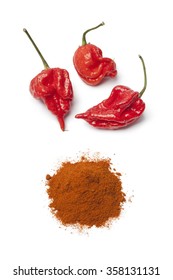 Fresh red hot scorpion chili peppers   chili powder white background