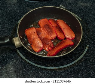 Fresh Red Links Frying In A Frying Pan