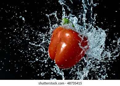 fresh red pepper gets hit by a water - Powered by Shutterstock