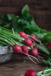 Fresh Red Radish With Green Leaves In A Bowl On A Dark Wooden Table. Organic Food Concept.