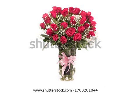 Fresh red rose bouquet in a clear vase in white background
